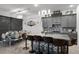 Modern kitchen featuring gray cabinets, mosaic backsplash, granite countertops, and a spacious island with barstool seating at 2264 Emerald Springs Dr, Apopka, FL 32712
