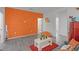 View of the charming room showcases the unique accent wall and retro-style red refrigerator at 2264 Emerald Springs Dr, Apopka, FL 32712