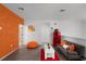 Bright living area with textured accent wall, playful decor, and a compact futon at 2264 Emerald Springs Dr, Apopka, FL 32712