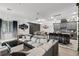 Expansive open floor plan with modern gray kitchen and a large sectional sofa in the living area at 2264 Emerald Springs Dr, Apopka, FL 32712