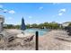 Relaxing community pool area with lounge chairs, tables, and umbrellas for residents to enjoy at 2264 Emerald Springs Dr, Apopka, FL 32712