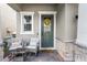 Inviting front porch with seating area, decorative wreath, and stylish stone accents at 2264 Emerald Springs Dr, Apopka, FL 32712