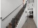 Modern staircase with sleek black railings and wood steps, leading to the upper level at 2264 Emerald Springs Dr, Apopka, FL 32712
