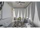 Bright sunroom featuring a modern rug, comfortable wicker furniture, and sheer curtains at 2264 Emerald Springs Dr, Apopka, FL 32712