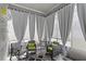 Charming sunroom with sheer curtains, wicker furniture, and a cozy rug for a relaxing atmosphere at 2264 Emerald Springs Dr, Apopka, FL 32712