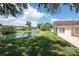 Serene backyard with lush lawn and lake views, perfect for relaxation and enjoyment at 23 Old Sunbeam Dr, South Daytona, FL 32119