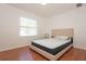 This bedroom offers a modern design with wood floors and natural light from a window at 23 Old Sunbeam Dr, South Daytona, FL 32119