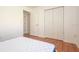 A cozy bedroom with wood floors and a closet provides comfort and functionality at 23 Old Sunbeam Dr, South Daytona, FL 32119