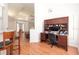 Bright home office setup with a large desk, storage, and wood-look floors at 23 Old Sunbeam Dr, South Daytona, FL 32119