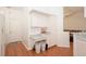 Kitchen with white cabinets, lots of storage, and wood-look floors at 23 Old Sunbeam Dr, South Daytona, FL 32119