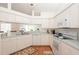 Bright kitchen with white appliances, ample counter space, and hardwood floors, perfect for preparing meals and entertaining guests at 23 Old Sunbeam Dr, South Daytona, FL 32119