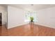 Bright living room area with wood-look floors, a modern light, and large windows at 23 Old Sunbeam Dr, South Daytona, FL 32119