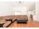 Spacious living room featuring hardwood floors and a large sectional couch, perfect for gatherings and comfortable everyday living at 23 Old Sunbeam Dr, South Daytona, FL 32119