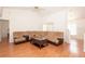 Open concept living room with hardwood floors and a sectional couch, offering a seamless flow for entertaining and relaxation at 23 Old Sunbeam Dr, South Daytona, FL 32119