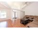Welcoming living room with hardwood floors, vaulted ceilings and doors, creating a bright and airy atmosphere for relaxation and entertainment at 23 Old Sunbeam Dr, South Daytona, FL 32119