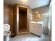 Tiled bathroom with a walk-in shower, white vanity, and a toilet with an open lid at 232 W Lafayette St, Winter Garden, FL 34787