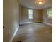 Bedroom featuring a large window, light gray walls, and light wood-look floors at 232 W Lafayette St, Winter Garden, FL 34787