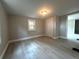 Bedroom features a closet and a large window, light gray walls, and light wood-look floors at 232 W Lafayette St, Winter Garden, FL 34787
