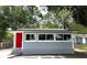 Newly renovated home featuring gray siding, black trim and a vibrant red door with updated windows at 232 W Lafayette St, Winter Garden, FL 34787