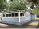 Charming exterior view showcasing gray siding, updated windows, and a well-maintained foundation at 232 W Lafayette St, Winter Garden, FL 34787