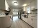 Beautiful kitchen with stainless steel appliances, white cabinets, subway tile backsplash and modern flooring at 232 W Lafayette St, Winter Garden, FL 34787