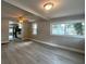 Open concept living room showcasing modern flooring, neutral paint, view into the kitchen and a ceiling fan at 232 W Lafayette St, Winter Garden, FL 34787