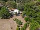 Expansive aerial view of the property surrounded by lush greenery and mature trees at 237 W Mcclendon St, Lady Lake, FL 32159