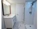 Modern bathroom featuring a white vanity, marble floors, and a tiled shower with rainfall showerhead at 237 W Mcclendon St, Lady Lake, FL 32159