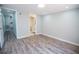 Bright bedroom featuring wood-look flooring, an ensuite bathroom, and an open doorway at 237 W Mcclendon St, Lady Lake, FL 32159