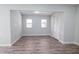 A bright bedroom featuring updated flooring and a large closet at 237 W Mcclendon St, Lady Lake, FL 32159