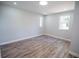 Cozy bedroom with two windows that allow for natural light and vinyl floors at 237 W Mcclendon St, Lady Lake, FL 32159