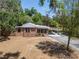 Inviting brick home featuring a carport and a well-kept front yard at 237 W Mcclendon St, Lady Lake, FL 32159