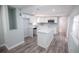 Bright kitchen with modern appliances, white cabinetry, and a center island with quartz countertops at 237 W Mcclendon St, Lady Lake, FL 32159