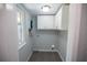 A convenient laundry room with cabinetry, a window, and washer-dryer hookups at 237 W Mcclendon St, Lady Lake, FL 32159