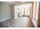 Living room features a ceiling fan, three large windows and new floors at 237 W Mcclendon St, Lady Lake, FL 32159