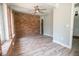 Living room showcases a brick wall, stylish ceiling fan, and updated floors at 237 W Mcclendon St, Lady Lake, FL 32159