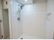 This modern walk-in shower features white tile and a shower head at 237 W Mcclendon St, Lady Lake, FL 32159