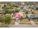 Aerial view of a home with a red roof, driveway, and a well-maintained yard at 2426 Abbey Ave, Orlando, FL 32833