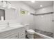 Bathroom featuring modern vanity, toilet, and newly tiled shower with mosaic accents at 2426 Abbey Ave, Orlando, FL 32833