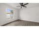 Bright bedroom with hardwood flooring, ceiling fan, and a large window at 2426 Abbey Ave, Orlando, FL 32833