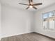 Bright bedroom with hardwood flooring, ceiling fan, and a large window at 2426 Abbey Ave, Orlando, FL 32833