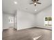 Bright and airy bedroom features wood-look floors, a ceiling fan, and a walk-in closet at 2426 Abbey Ave, Orlando, FL 32833