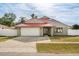 Charming home with a red roof, a two-car garage, and a well-maintained front yard at 2426 Abbey Ave, Orlando, FL 32833