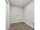 Small, clean laundry room with light wood-look flooring and washer and dryer hookups at 2426 Abbey Ave, Orlando, FL 32833
