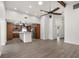 Living room with an open floor plan leads into an island kitchen with wood cabinets and stainless appliances at 2426 Abbey Ave, Orlando, FL 32833