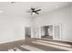 Open living room boasts wood-look floors, a ceiling fan, recessed lighting, and French doors at 2426 Abbey Ave, Orlando, FL 32833