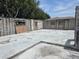 Damaged home featuring cinder block walls, concrete floors, and boarded-up windows at 2467 Myakka Dr, Orlando, FL 32839