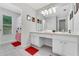 Bright bathroom with double vanity, ample counter space, tiled floors, and a separate toilet and shower room at 2609 Dinville St, Kissimmee, FL 34747