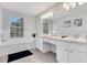 This bathroom features tile floors, a built-in tub, and a dual sink vanity with ample counter space at 2609 Dinville St, Kissimmee, FL 34747