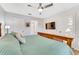 Bright bedroom with neutral carpet, simple bedding, wooden furniture, and ample sunlight at 2609 Dinville St, Kissimmee, FL 34747